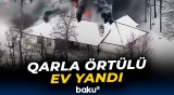 ABŞ-də qarla örtülü ev alovlandı